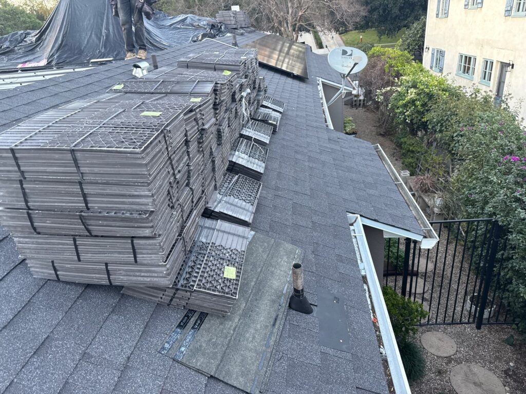 Roofing crew replacing shingles on a Glendale, CA bungalow during a sunny afternoon