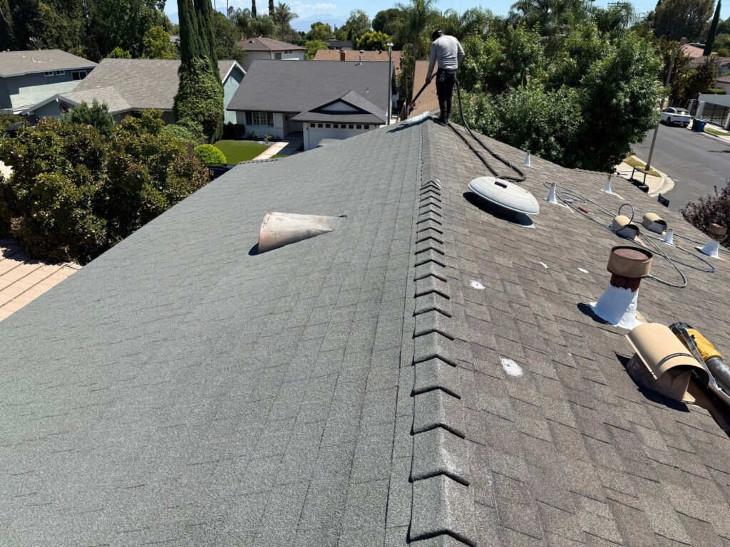 Roofing specialist evaluating weathered tiles on a Los Angeles commercial building