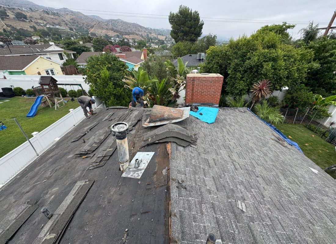 Crew removing old roofing and installing new materials on Pasadena home