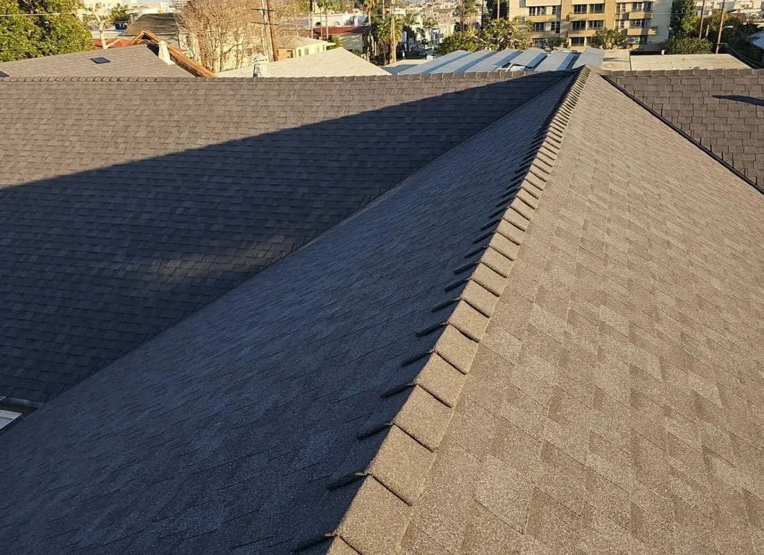 Roofing Services in West Hollywood, CA crew inspecting flashing and worn shingles on a residential roof
