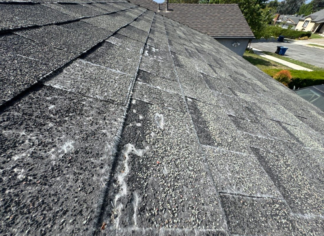 Specialist restoring weathered roof tiles on a Los Angeles apartment complex with professional tools