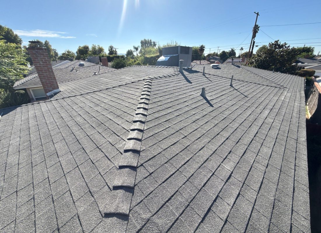 Homeowner meeting roofer during roof replacement planning at damaged Inglewood residence