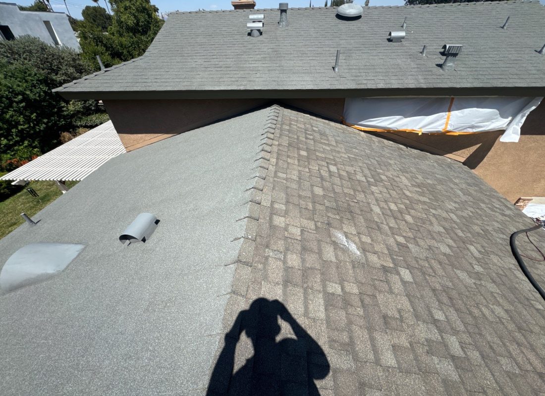 Roofing expert installing waterproof underlayment on Sherman Oaks, CA rooftop, highlighting safety and precision