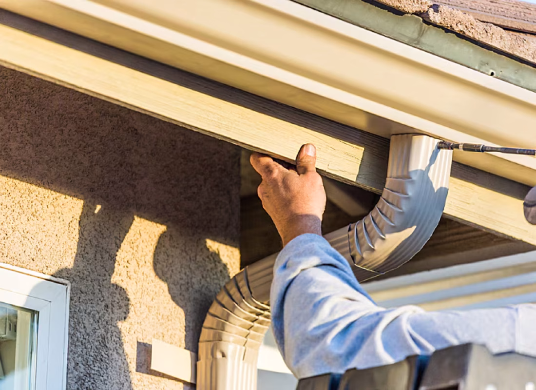 Inspector evaluating roof under bright Los Angeles sunlight for code compliance and safety